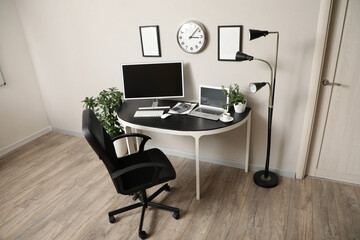 Interior of office with workplace, computer and comfortable chair
