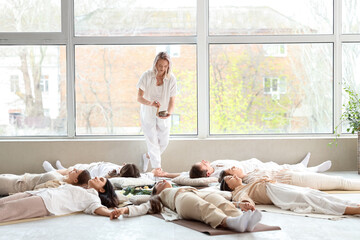 Group of people meditating while lying on floor