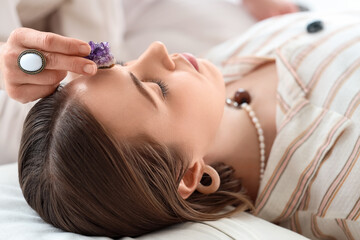 Healer working with young woman, closeup. Crystal therapy