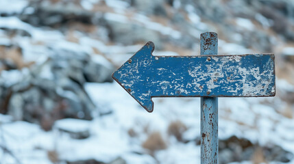 Blue Arrow Sign. Rustic arrow sign pointing left with winter background.