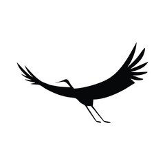 A black vector silhouette of a flying stork with wings evokes freedom in flight