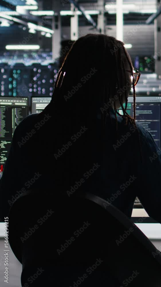 Poster vertical video server room programmer interpreting ai generated data analytics graphs, putting on he