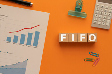 There is wood cube with the word FIFO. It is an abbreviation for first in, first out as...