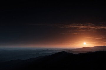 Obraz premium Serene sunset over a mountain range. Warm hues paint the sky.