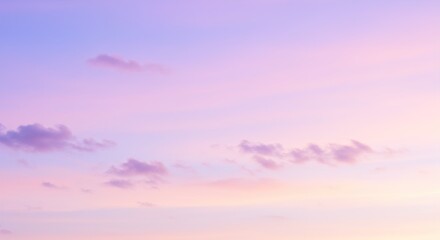 Obraz premium A serene pastel sky at sunset, with soft pink, purple, and blue hues blending together, creating a peaceful and calming atmosphere