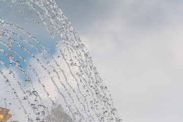 Splashes and jets of water against light background.