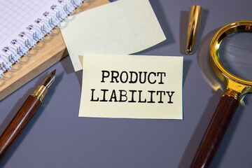 Product liability message written on white paper with blurry lake background.