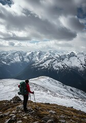 Fototapeta premium Woman hiking in the snowy mountains enjoying the stunning alpine view