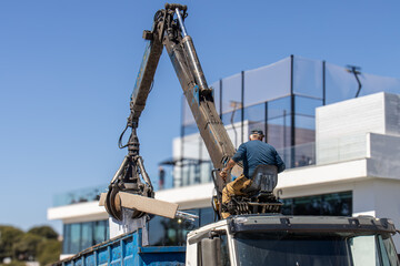 man operating  hydraulic industrial claws crane truck 