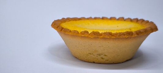Egg tarts that are crispy on the outside and soft on the inside. Egg tarts that have a rich and creamy egg aroma. Egg tarts on white background.