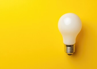 A single white lightbulb on a yellow background