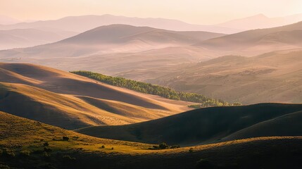 Fototapeta premium Scenic Golden Hour Over Rolling Mountain Ranges with Light Fog and a Dramatic Horizon