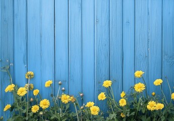 Yellow flowers bloom before a blue wooden fence