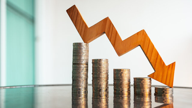 A pile of coins slowly decreasing with an arrow pointing down. Concept of a recessionary economy due to higher prices and tariffs.