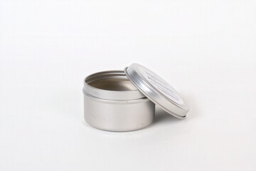 Open silver metal tin container with lid on white background

