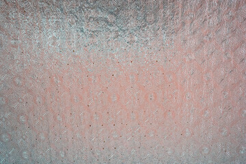 Intricate textured pattern with soft pink hues.
