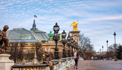 Blonde woman walking on the bridge - Alexandre III Bridge, Paris France