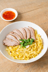 dried duck noodles in white bowl