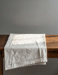 Editorial AI Generated - Plain White Cloth Napkin with Wrinkles on Rustic Wooden Surface for Tableware or Dining Setting Decoration