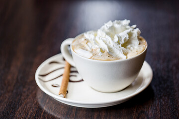 Cup of whipped cream Vienna coffee with cinnamon stick