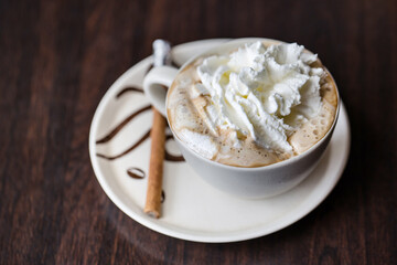 Cup of whipped cream Vienna coffee with cinnamon stick