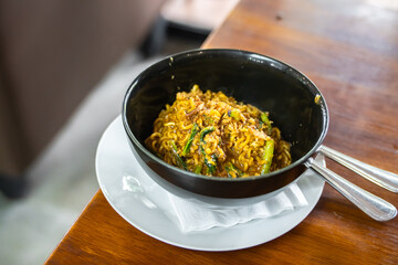 Spicy Bangladeshi noodles in a black bowl. A delicious food typical of Medan, North Sumatra. (Mie Bangladesh)