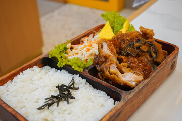 Chicken katsu and rice meal with carrot, cabbage and lettuce vegetables