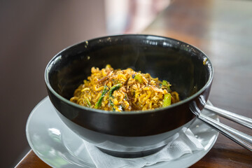 Spicy Bangladeshi noodles in a black bowl. A delicious food typical of Medan, North Sumatra. (Mie Bangladesh)