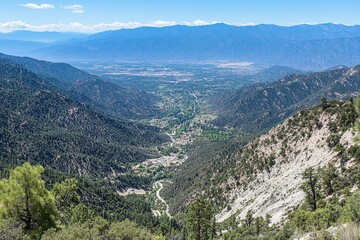 Fototapeta premium Mountain valley vista, lush greenery, winding road