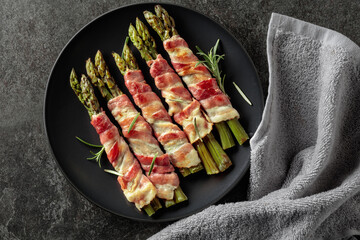 Grilled green asparagus wrapped in bacon.
