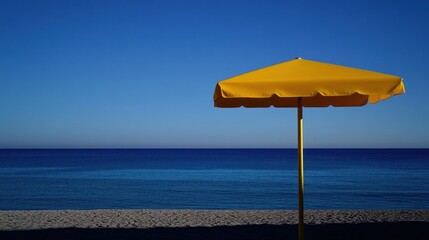 Solitary yellow beach umbrella on a sunny shore