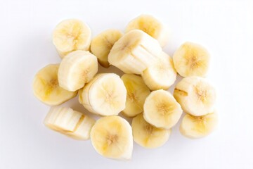 Fresh sliced banana pieces scattered on white background
