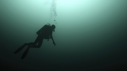 Fototapeta premium A lone diver swimming deep in dark underwater environment