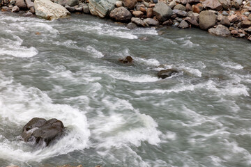 The water is flowing rapidly and is surrounded by rocks