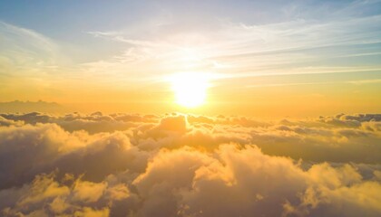 Obraz premium A breathtaking sunrise above the clouds, casting warm golden hues across a serene sky, creating a peaceful and uplifting atmosphere