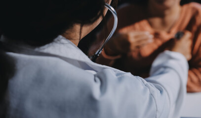 The doctor examines the patient's heart to analyze and listen to whether the heart rhythm is...
