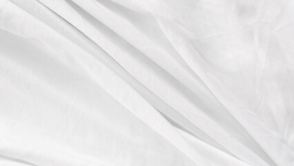 Fototapeta premium Soft wrinkled white bedsheet background used for cozy bedroom interior..