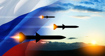 Fired missiles fly to the target. Missiles at the sky at sunset with Russian flag. Missile defense,...