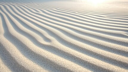 Obraz premium A close-up view of a sandy beach with ripples and waves.