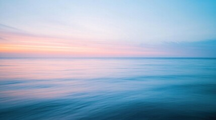 Fototapeta premium Calm Ocean Waves at Sunset with Soft Colors in the Sky and Water Surface