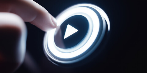 Glowing play button pressed by finger – high-tech media interface concept background
