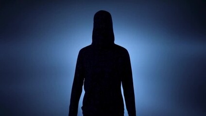 Mysterious silhouette, shadowy and enigmatic, hooded figure, against a moody blue backdrop