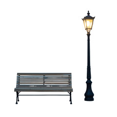 A park bench sits next to a glowing street lamp illuminating the dark night with its soft light