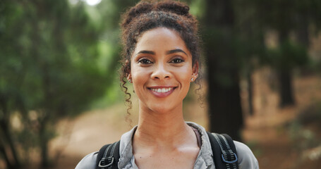 Hiking, smile and portrait of woman in nature with backpack for exercise, workout and walking. Fitness, travel and happy person in forest, trail and woods for trekking, adventure and explore outdoor