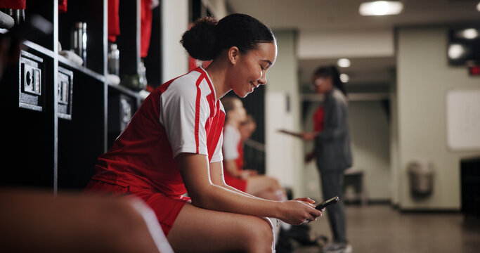 Phone, woman and athlete in locker room for game, match or practice with scrolling on social media. Happy, relax and female soccer player with cellphone for networking on mobile app in changing area.