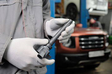 Car. Car service.Maintenance. Replacing the ignition coil. An auto mechanic inspects the ignition...