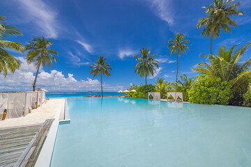 Stunning landscape infinity swimming pool sunny sky clouds. Tropical resort hotel in Maldives. Fantastic relax and peaceful vibes, chairs, loungers canopy umbrella, palm leaves. Luxury travel vacation