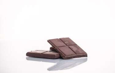 slices of delicious dark chocolate on a light background.