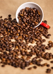 red cup with coffee beans on a light background.