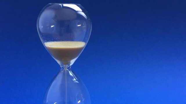 sand flowing through an hourglass 